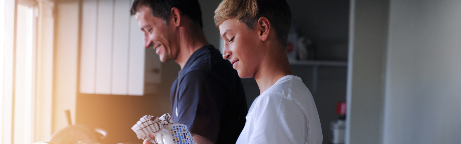 Father and son washing up at home